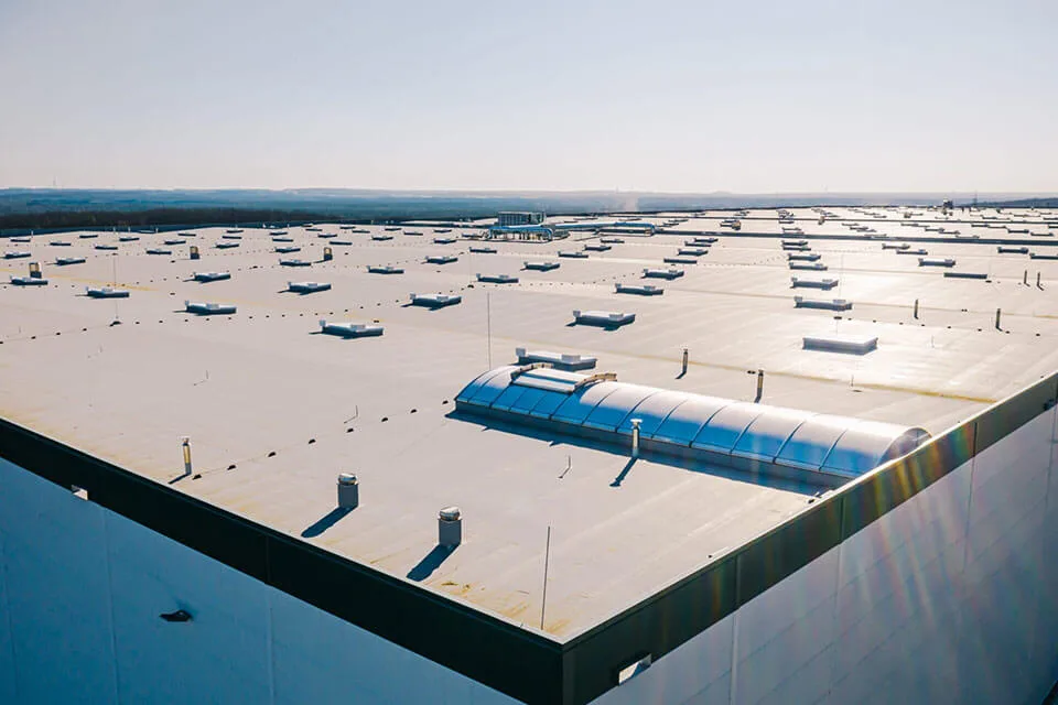 Large,Roof,Of,Factory,With,Roof,Ventilators,,Drone,Shot,From